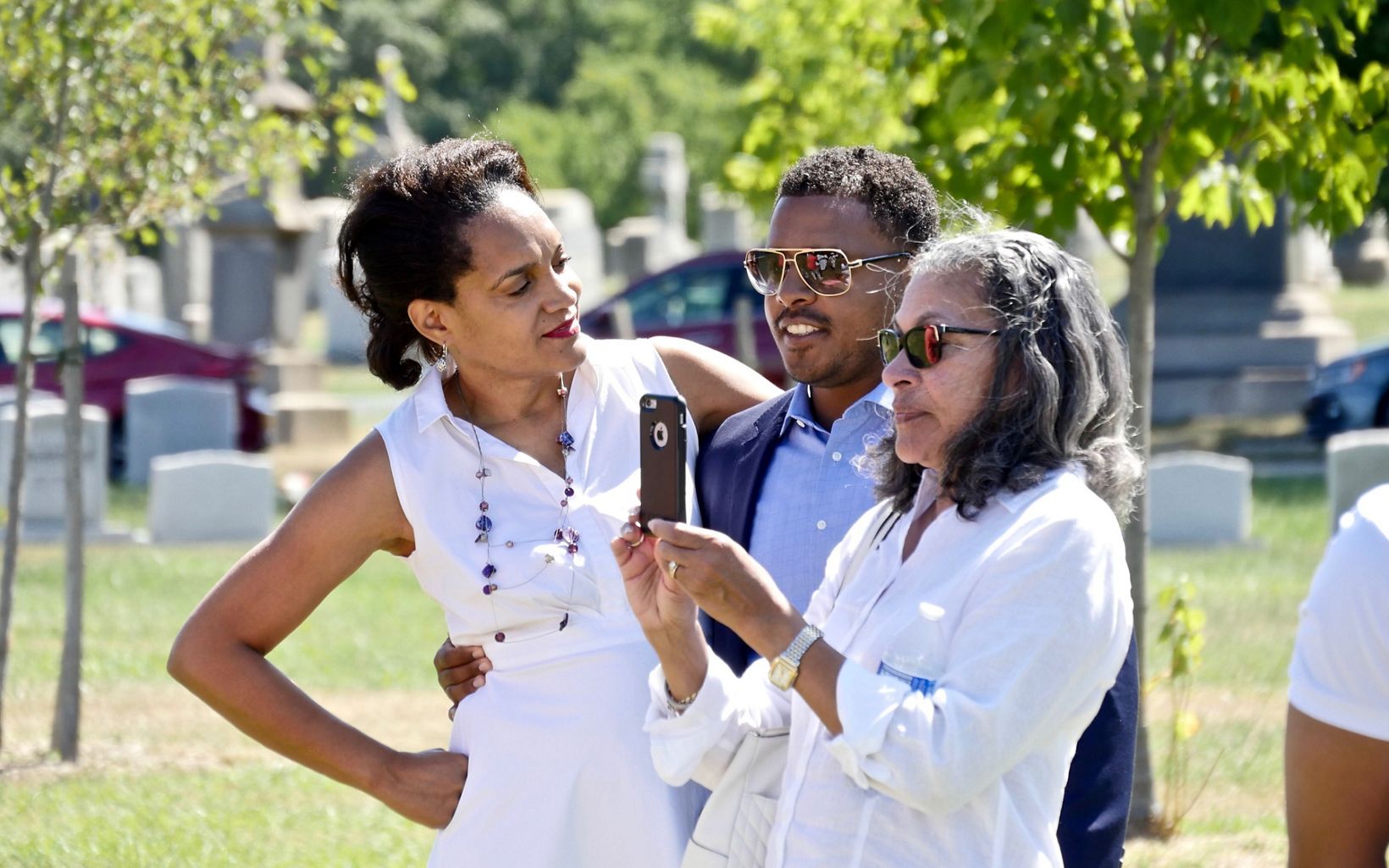 Event organizer Gayle George (l) with extended family members during a celebration of ancestors John and Arabella Weems, freedmen buried at Mt. Olivet Cemetery.
