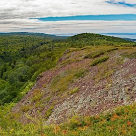 View of the surrounding forest and Lake Superior from the top of Mt. Baldy in Michigan.