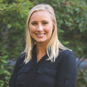 A headshot of Myrilla Hartkopf. She has long blond hair and is wearing a dark blue shirt.