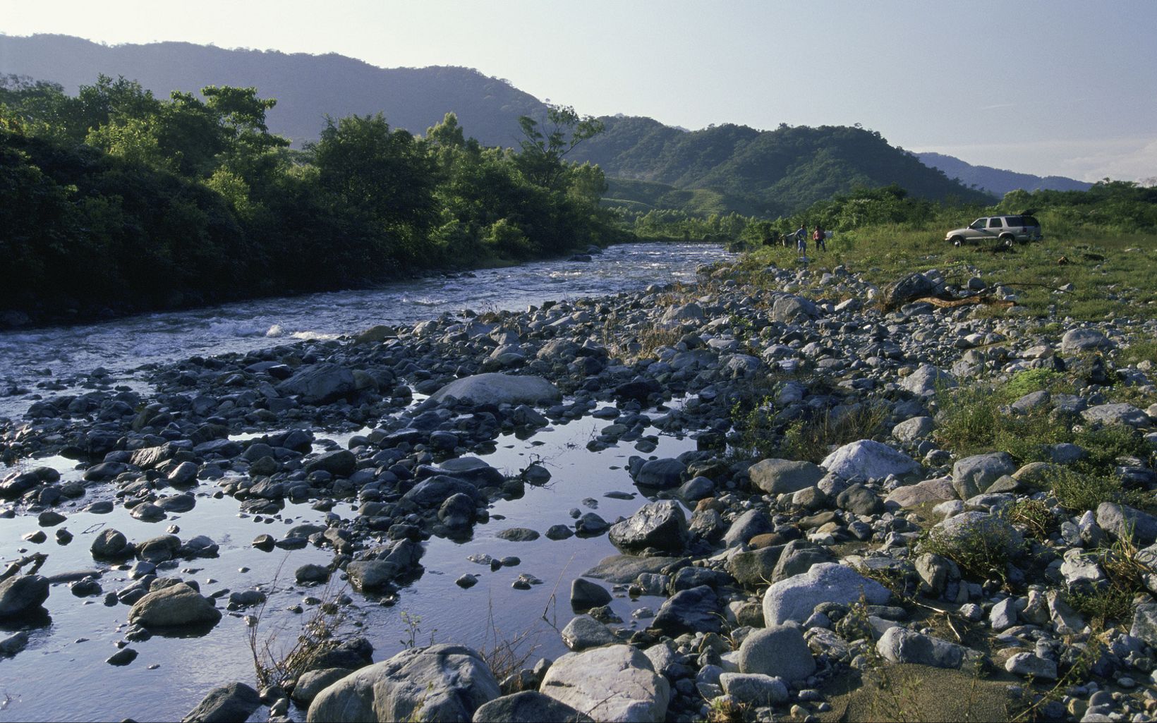 A river flows west off the Sierra Madre watershed through the agricultural community of Vienes Comunales San Antonio towards Pijijiapan and the Pacific ocean; Chiapas, Mexico       