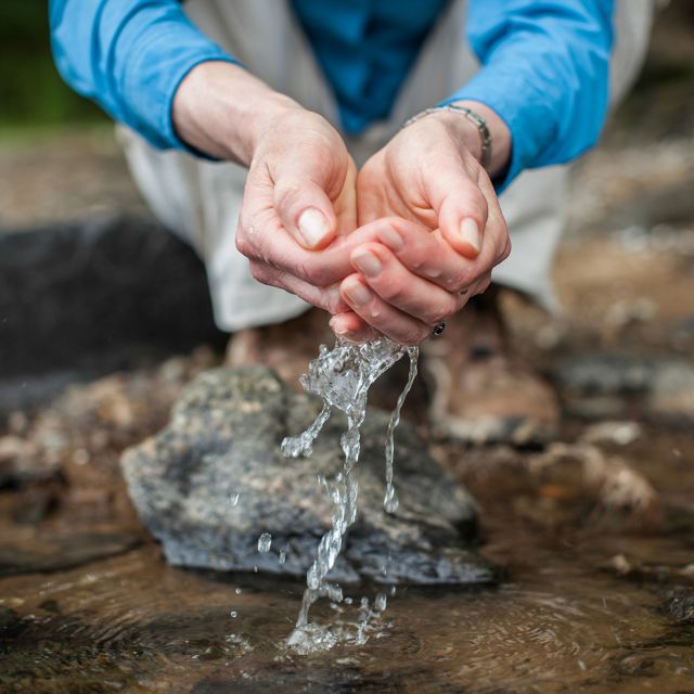 (ALL RIGHTS) July 2013. A woman scoops water with her hands.