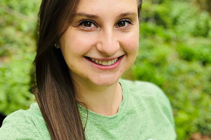 Morgan Johnson headshot. A smiling woman wearing a green tee-shirt smiles at the camera.