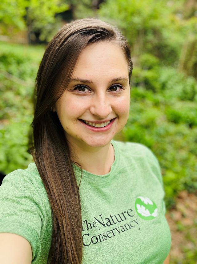 Morgan Johnson headshot. A smiling woman wearing a green tee-shirt smiles at the camera.