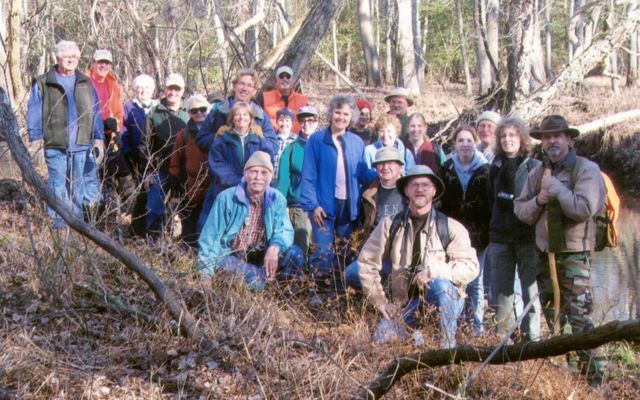 A large group of people pose together for a photo taken during a volunteer workday.