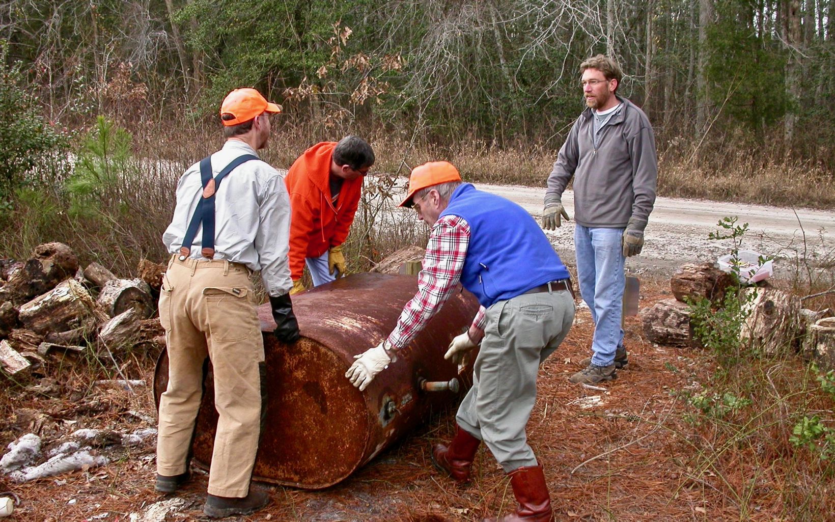 Nassawango Stewardship Committee members remove a rusted oil tank during a workday at the preserve.