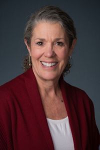 A headshot of a woman with short gray hair. 