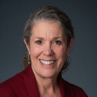 A headshot of a woman with short gray hair.