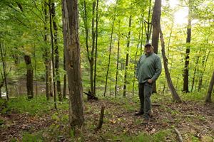 TNC's Nathan Herbert stands in the forests of Douglas Woods.