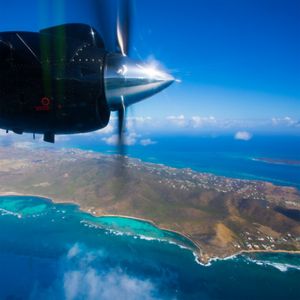 plane propellor spins with view of island in background