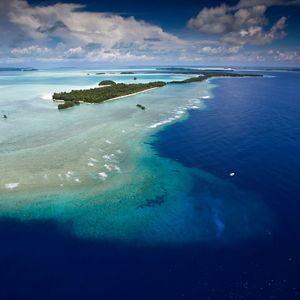 aerial view of island, blue water and sandbars