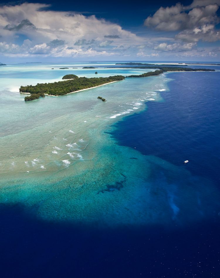 aerial view of island, blue water and sandbars