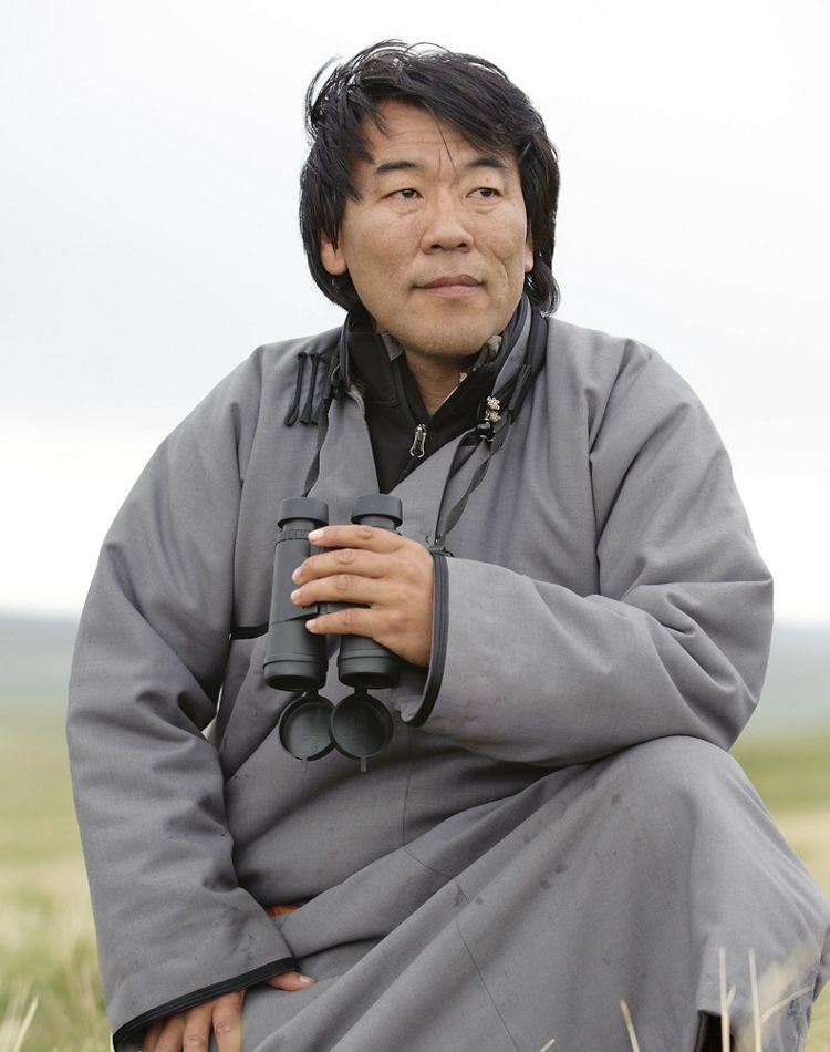 close up portrait of man outside holding binoculars