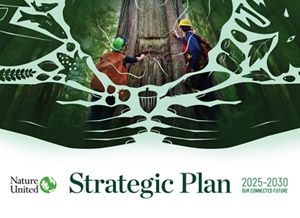 Two people standing in front of a tree.