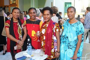 A group of 4 women stand together.