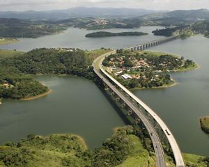 Aerial view of a multi-lane highway and reservoir.