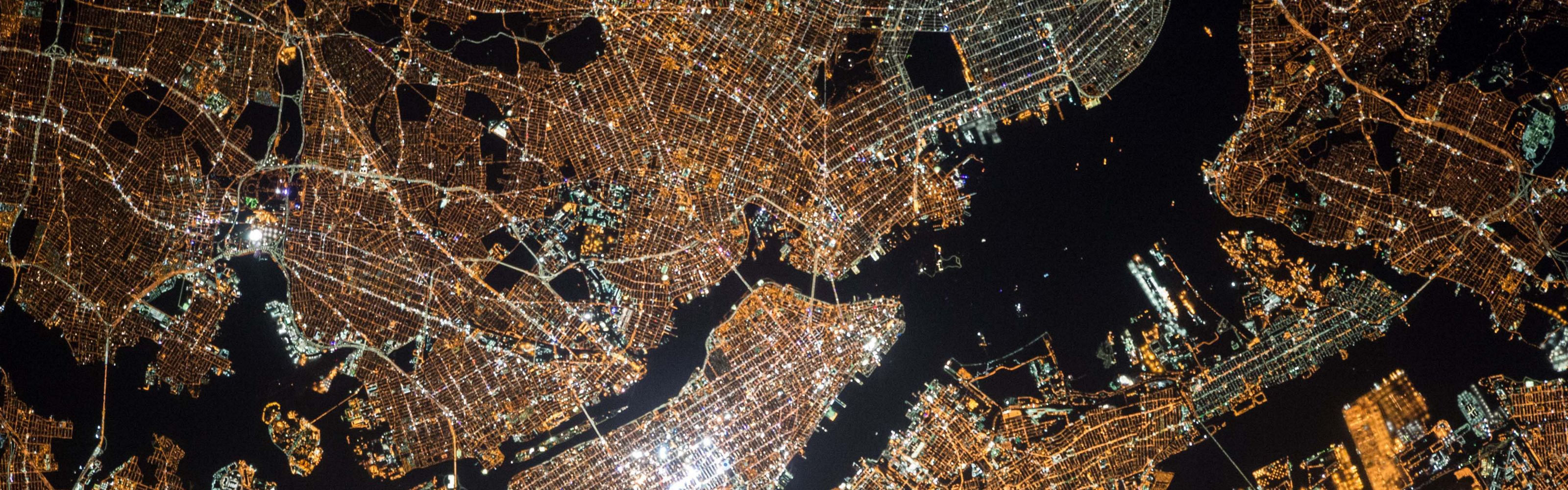 Aerial view of a city grid at night.