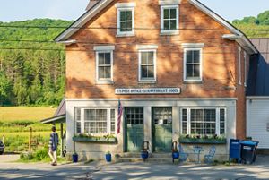 Brick building with post office sign. 