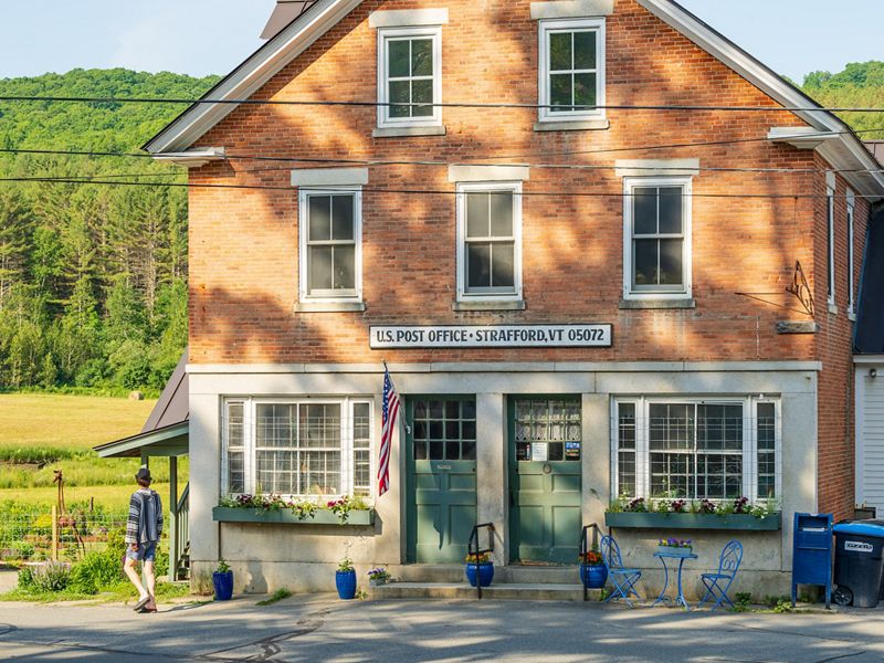 Brick building with post office sign.