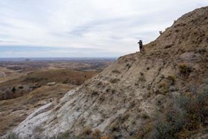 A hunter looks on the view in North Dakota's Badlands.