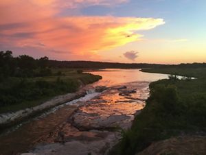 The sun rises over the winding river at the Niobrara Valley Preserve, the largest tract of intact grasslands, which offers climate resiliency.