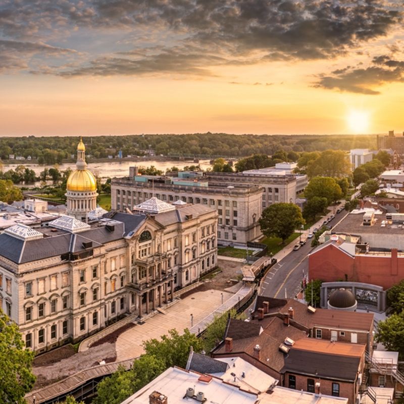 Aerial panorama of Trenton New Jersey skyline and state capitol at sunset.