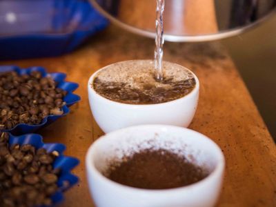 Rose grinds and tastes each coffee sample to ensure high quality.