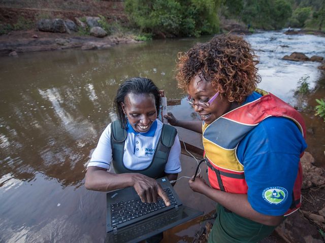 Faith Mbathi and Jane Njoroge measure water quality and quantity in Gura River for the Upper Tana-Nairobi Water Fund.
