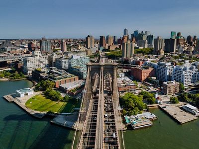 The majestic Brooklyn Bridge in New York Brooklyn downtown skyline side view.