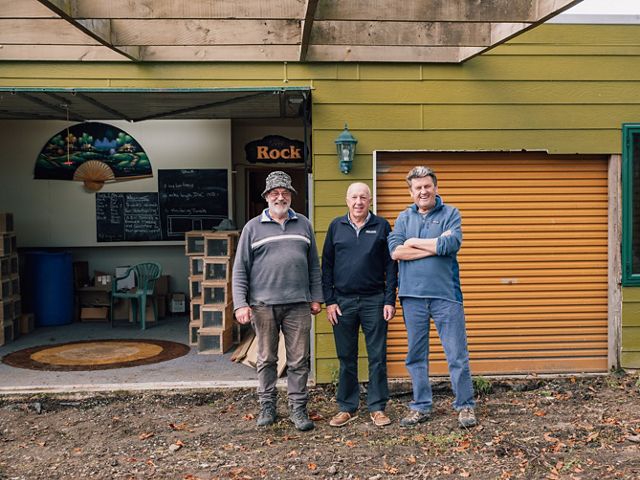 Mark Altoft, Rodger Jones, and Trevor Easton in front of the building donated to Picton Dawn Chorus.