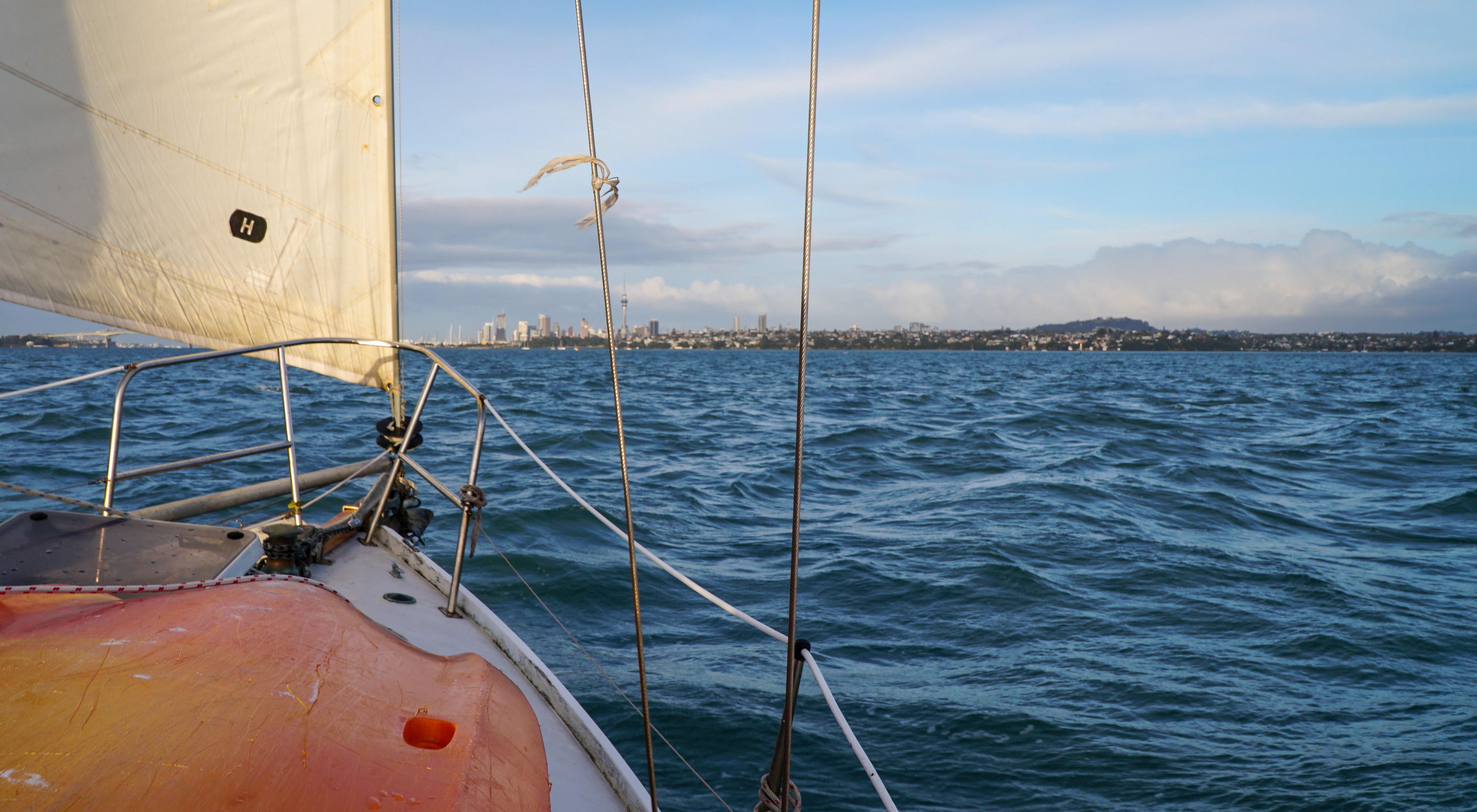 View from a sailboat in a harbor.