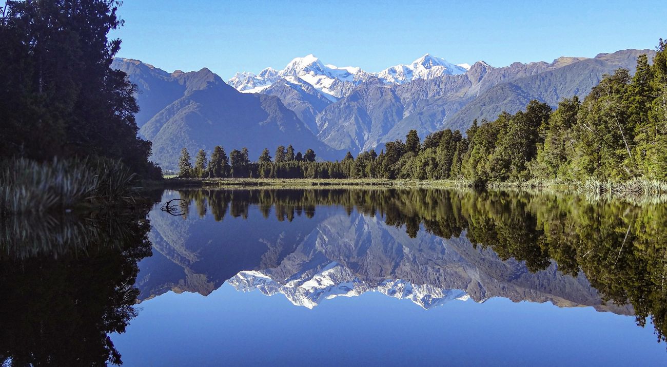 A mountain scene reflected in a lake.