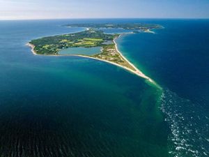 An aerial view of Block Island as seen from the north surrounded by blue ocean.