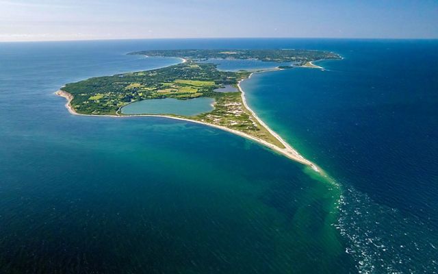 An aerial view of Block Island as seen from the north surrounded by blue ocean.