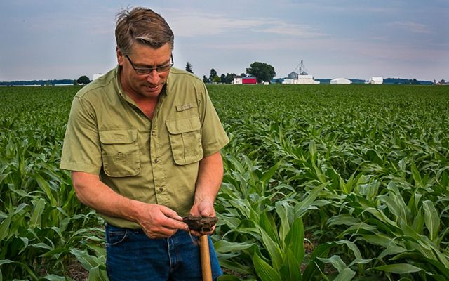 Farmer Les Seiler demonstrates healthy soil.