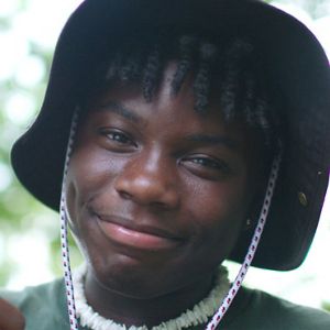 Teen boy smiles at camera.