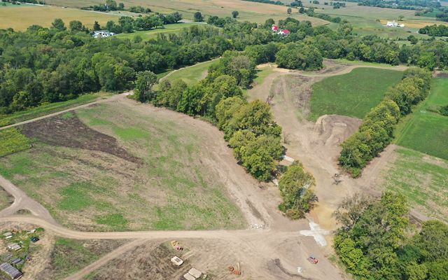 Aerial view of newly dug stream beds winding through patches of forest.