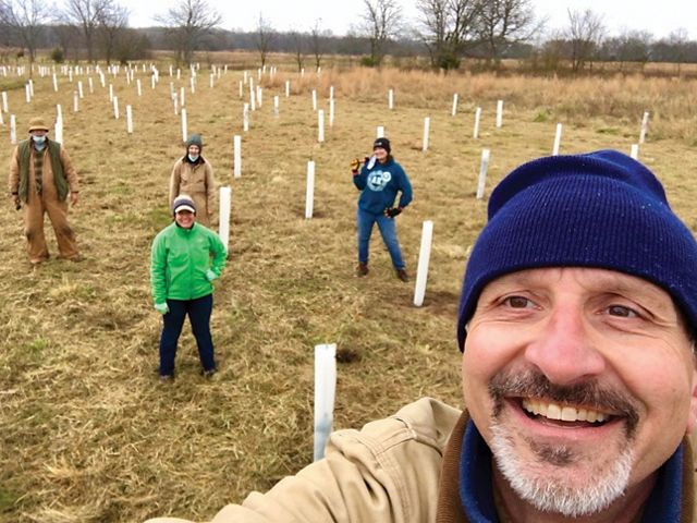 Group photo of State Director Mike Fuhr and volunteers planting trees.