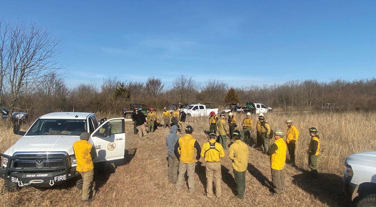 Group of fire practitioners preparing to conduct a controlled burn.
