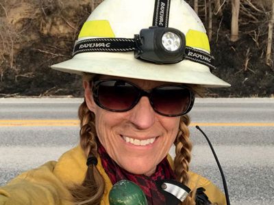 Woman wearing controlled burn gear.
