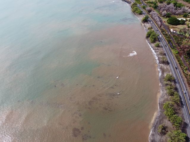 Aerial view of heavy sediment in ocean waters along the coast of Hawaii.