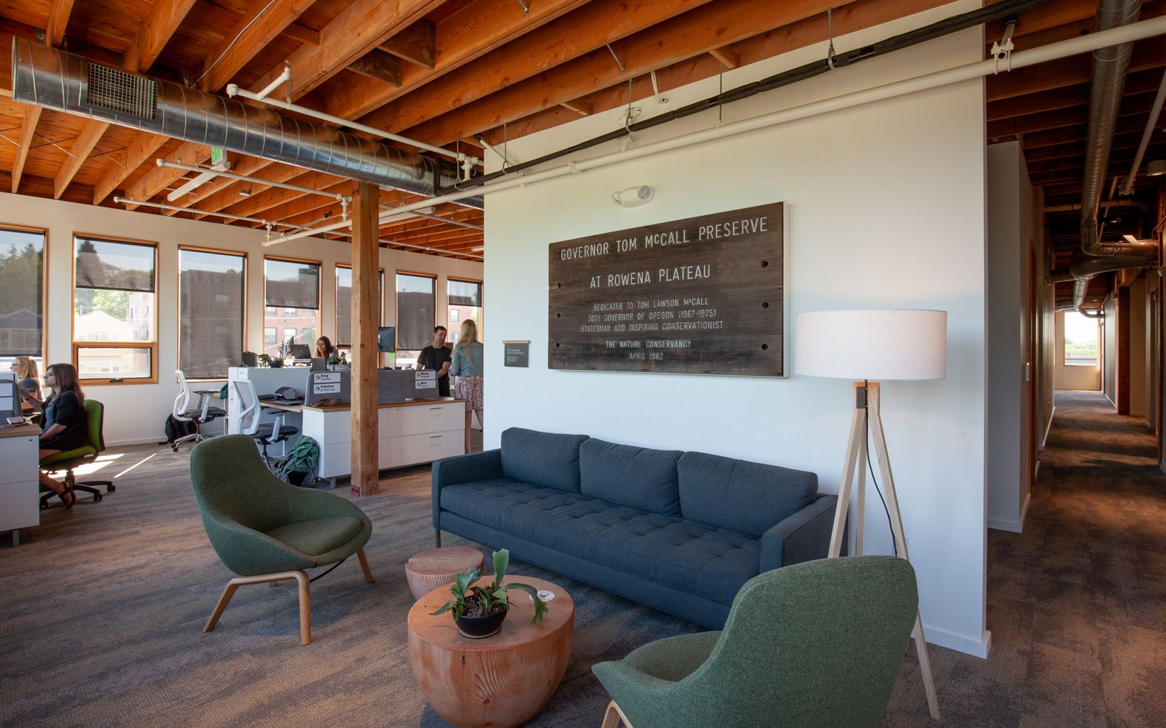 
                
                  A variety of workplaces Staff and guests find multiple areas to work and meet. This lounge area, adjacent to the open workspace, features retired signage from TNC's Tom McCall Preserve near Rowena. 
                  © Shawn Records
                
              