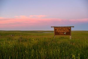 Sunset over a sign in the prairie.