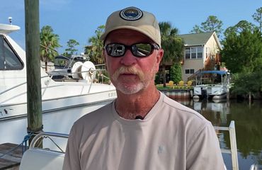 Oysterman Pasco Gibson standing on the dock.