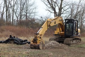 Yellow construction equipment and black piping.