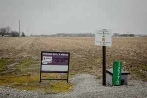 Two signs about soil and water conservation in an agricultural field.