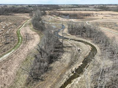 Wannemacher Reserve after OMP work showing a winding stream and field.