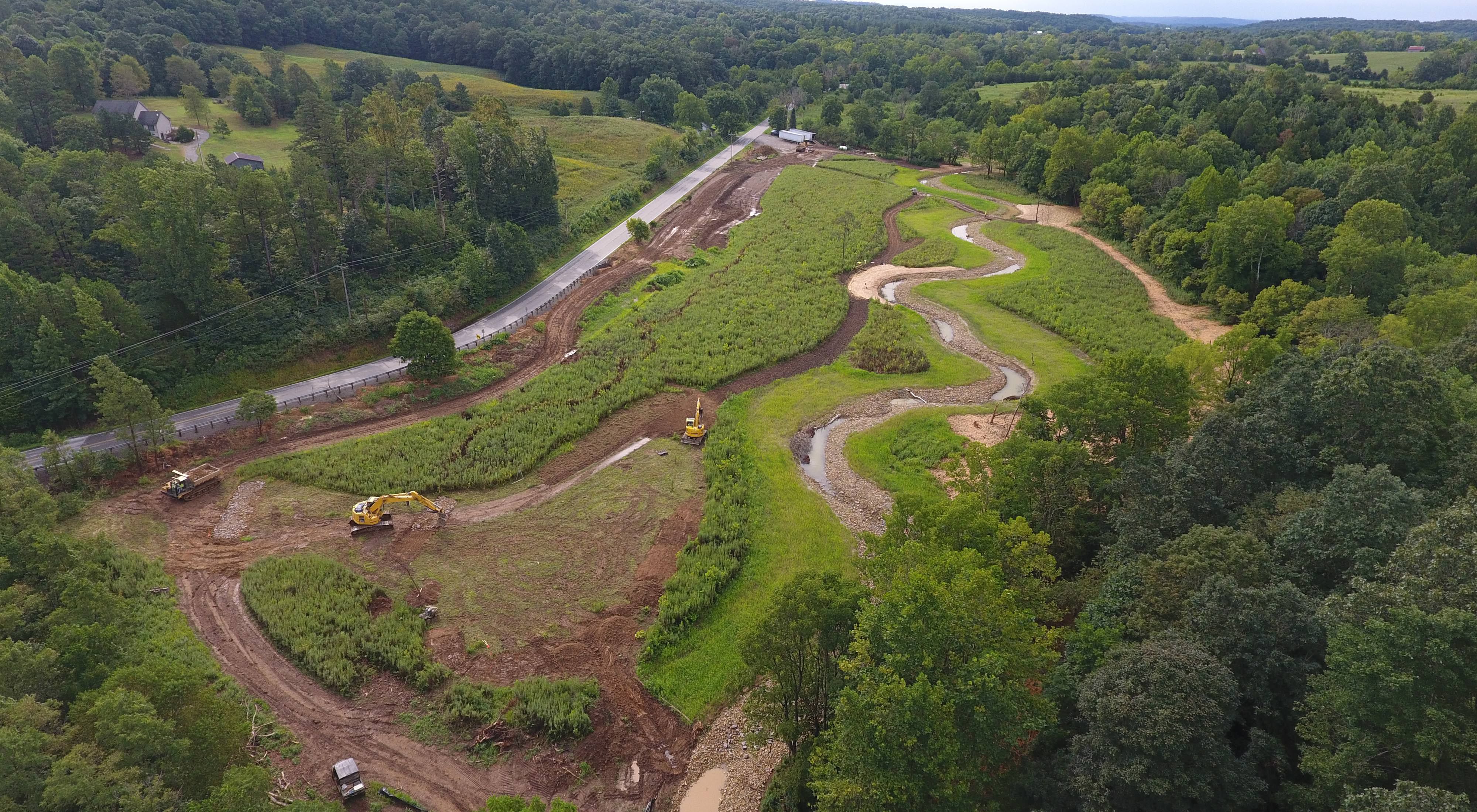 Construction equipment dig new stream bed at Strait Creek.