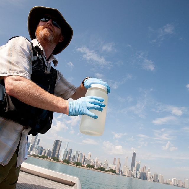 A scientists takes water samples on Lake Michigan