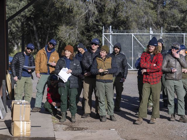 Group of people listening to instructions.