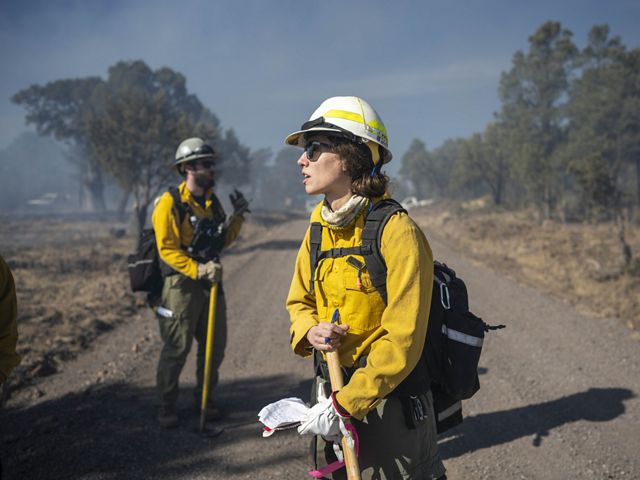 Person standing in fire gear.